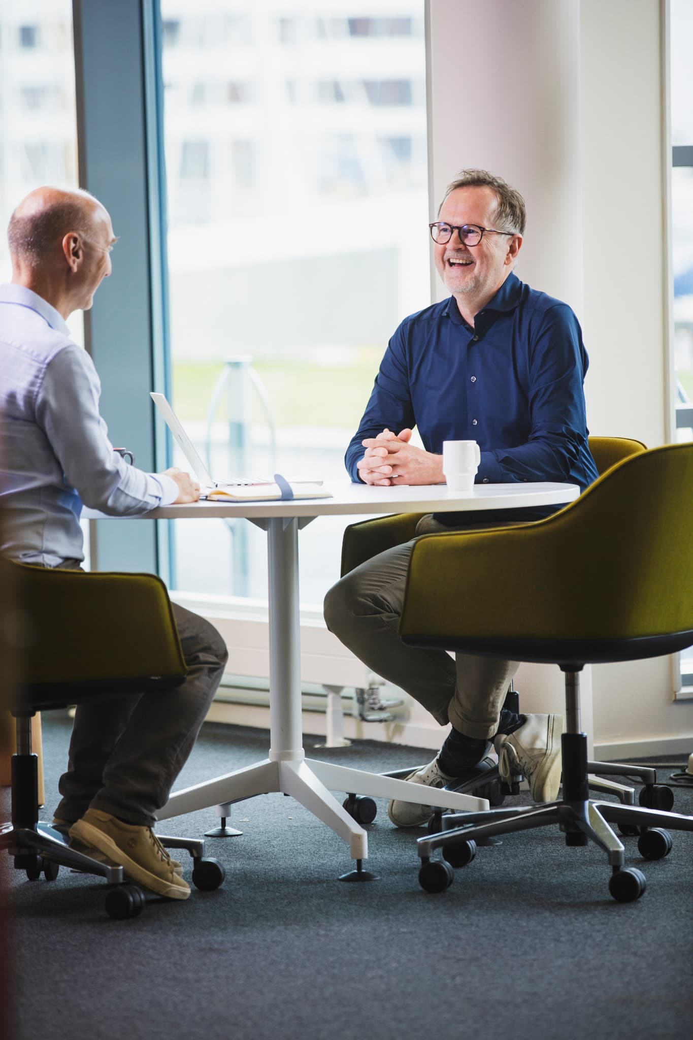 Two professionals discussing recruitment in a modern office